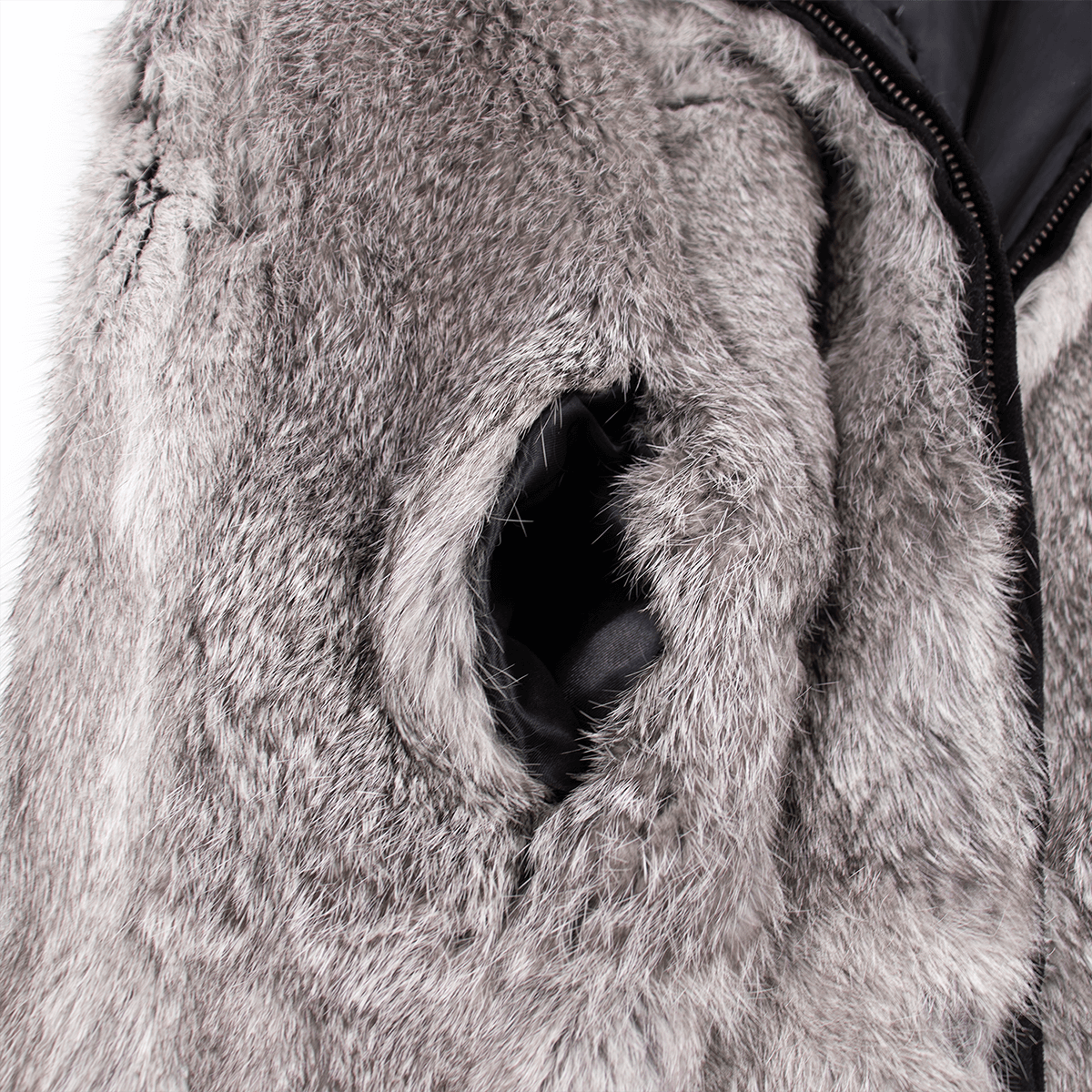 Pocket on a gray rabbit fur vest with black lining