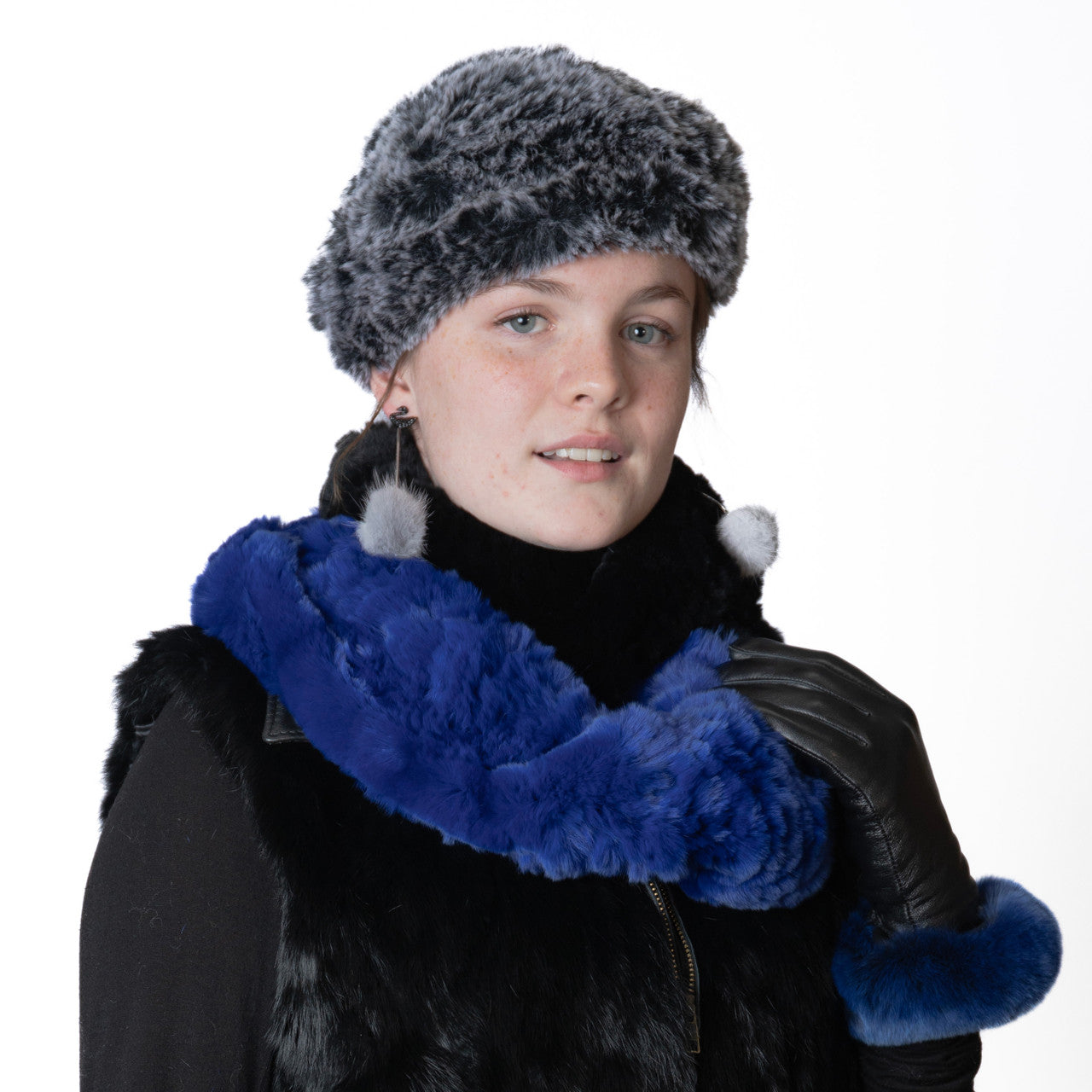 Woman wearing gray mink fur earrings and a fur beret