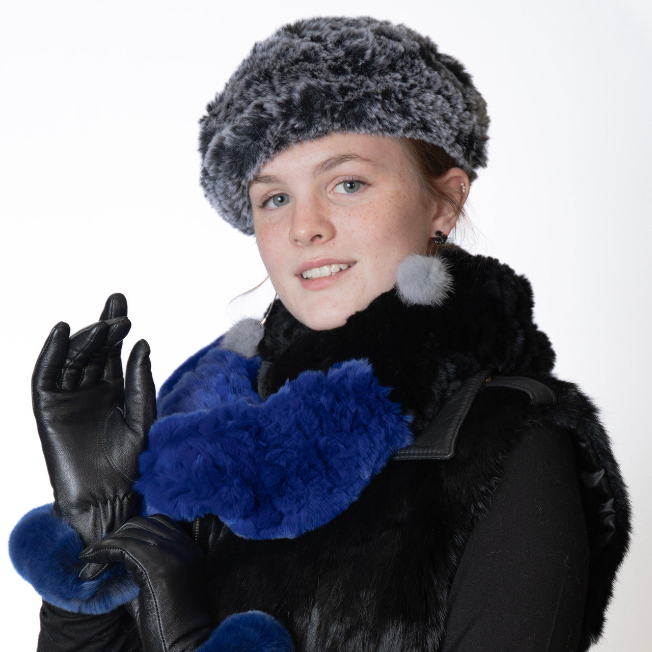 Woman wearing gray mink fur earrings, fur beret and black leather gloves