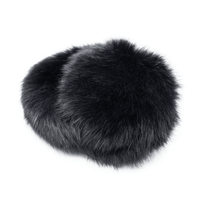 Folded up black long haired rabbit fur earmuffs with a fuzzy band