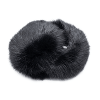 Folded up black long haired rabbit fur earmuffs with a fuzzy band