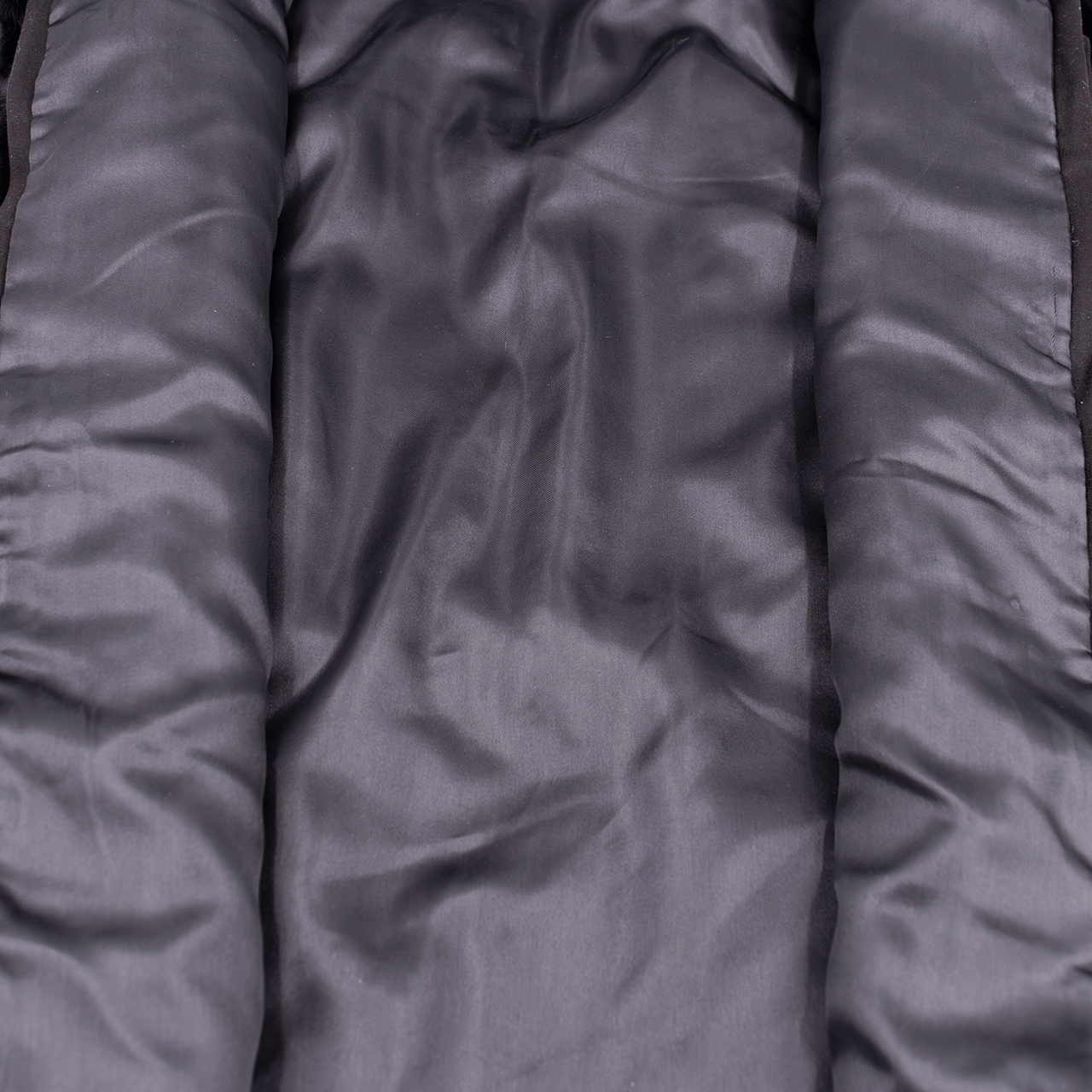 Black satin lining of a black rabbit fur vest