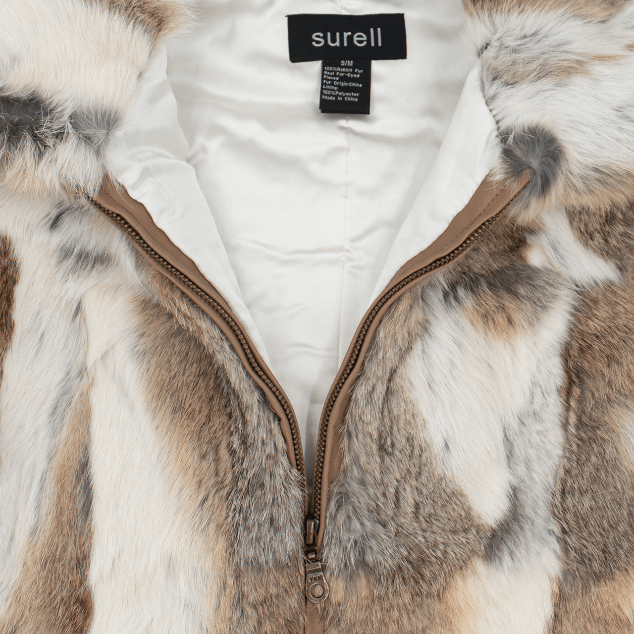 Close up of zipper on white and light brown rabbit fur vest